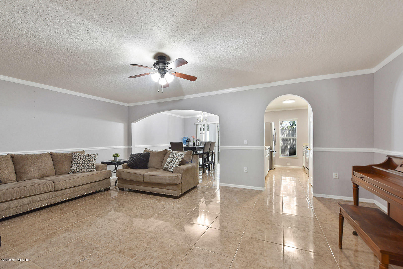 10543 Autumn Trace Road Jacksonville, FL 32257 - Photo 6 of 25 a living room with furniture and a chandelier