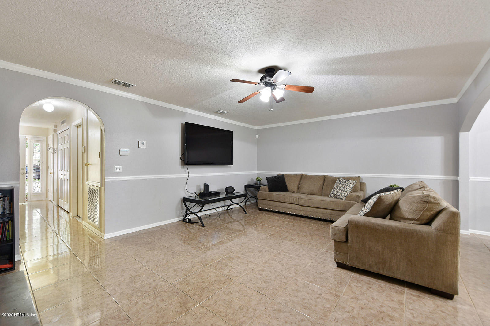 10543 Autumn Trace Road Jacksonville, FL 32257 - Photo 7 of 25 a living room with furniture and a flat screen tv