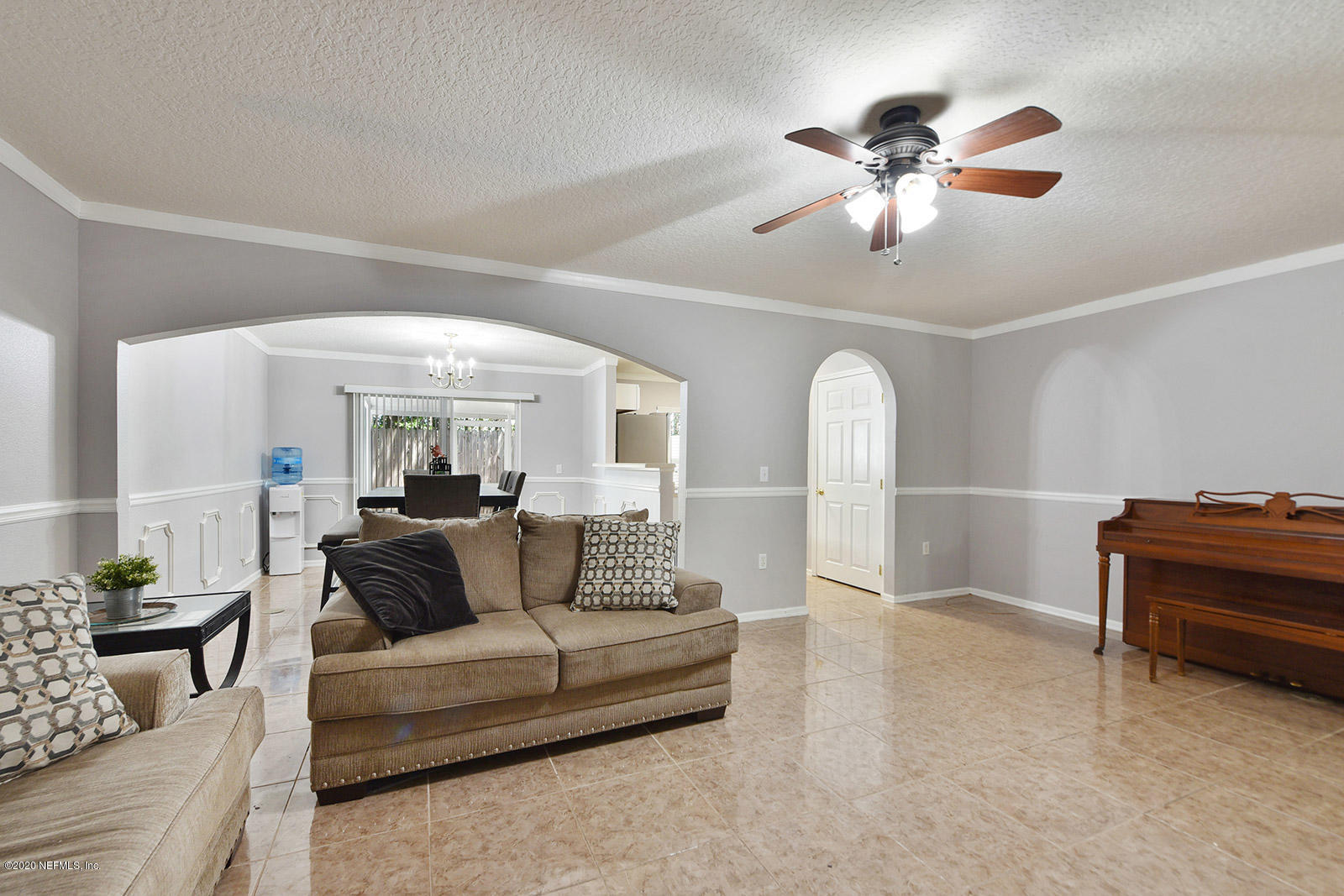 10543 Autumn Trace Road Jacksonville, FL 32257 - Photo 8 of 25 a living room with furniture and a chandelier