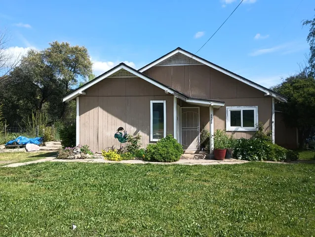 a front view of house with yard and green space