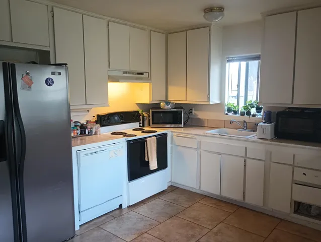 a kitchen with a sink stove and refrigerator