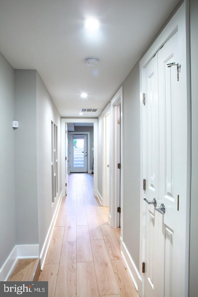 720 East Capitol Street Northeast Washington, DC 20003 - Photo 6 of 12 a view of a hallway with wooden floor and a bathroom