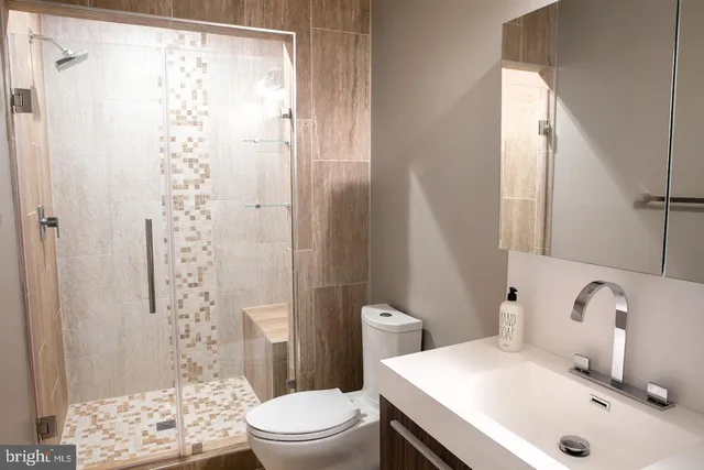 a bathroom with a sink a toilet and shower curtain