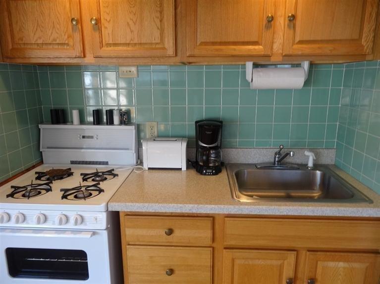 191 Captain Chase Road Dennis Port, MA 02639 - Photo 8 of 16 a kitchen with a stove and a cabinets