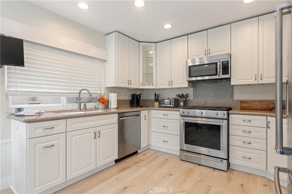 20151 Big Bend Lane Huntington Beach, CA 92646 - Photo 12 of 28 a kitchen with stainless steel appliances granite countertop a stove a sink and a microwave