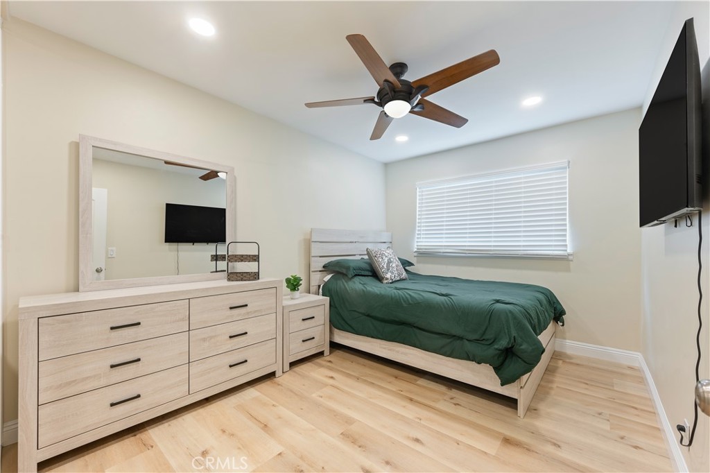 20151 Big Bend Lane Huntington Beach, CA 92646 - Photo 13 of 28 a bedroom with a bed a flat screen tv and a window