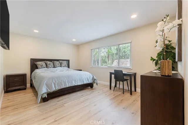 a bedroom with a bed and table chair