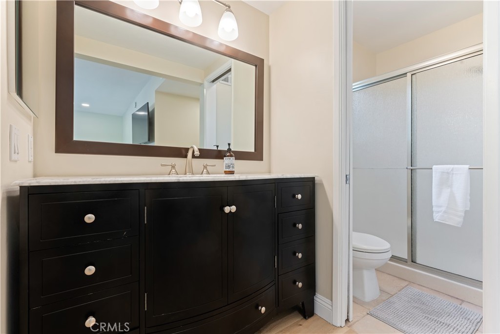 20151 Big Bend Lane Huntington Beach, CA 92646 - Photo 17 of 28 a bathroom with a double vanity sink toilet and mirror