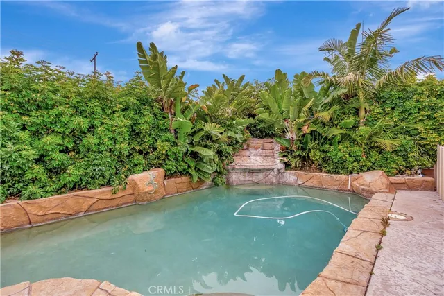 a view of a backyard with plants and a patio