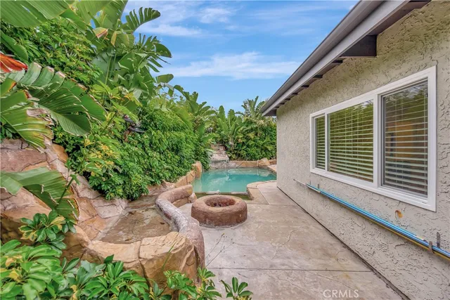 a view of a backyard with plants and a patio
