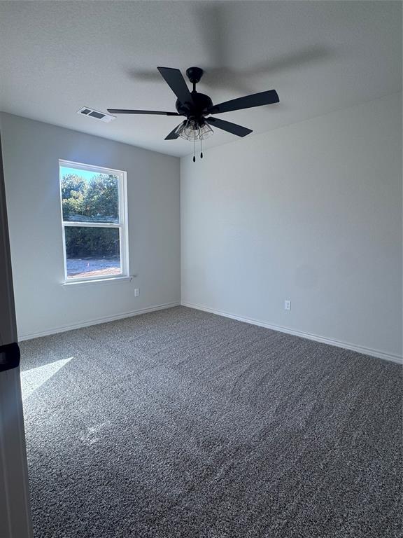 1013 East Bradshaw Road Springtown, TX 76082 - Photo 6 of 6 an empty room with a ceiling fan and window