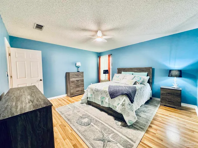 a bedroom with a bed and a dresser