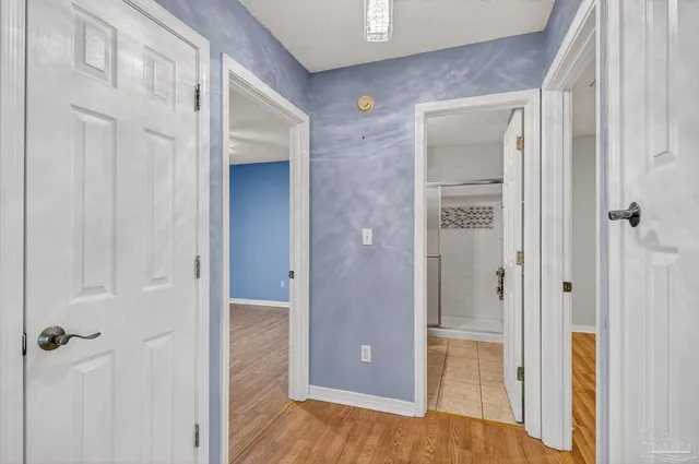 a view of a hallway with wooden floor