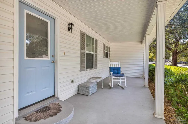 a view of a patio with table and chairs and potted plants