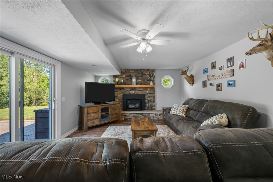 10229 Crawford Road Homerville, OH 44235 - Photo 15 of 42 Living room with a textured ceiling, wood finished floors, and a ceiling fan