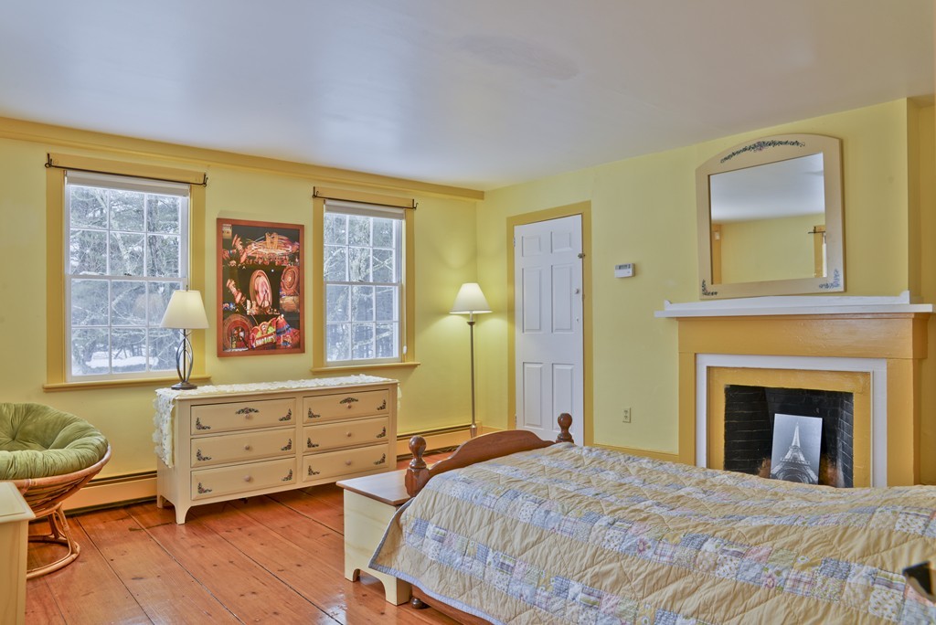 20 Topsfield Road Boxford, MA 01921 - Photo 17 of 30 a bedroom with a bed and a fireplace
