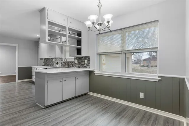 a kitchen with a wooden floor and window