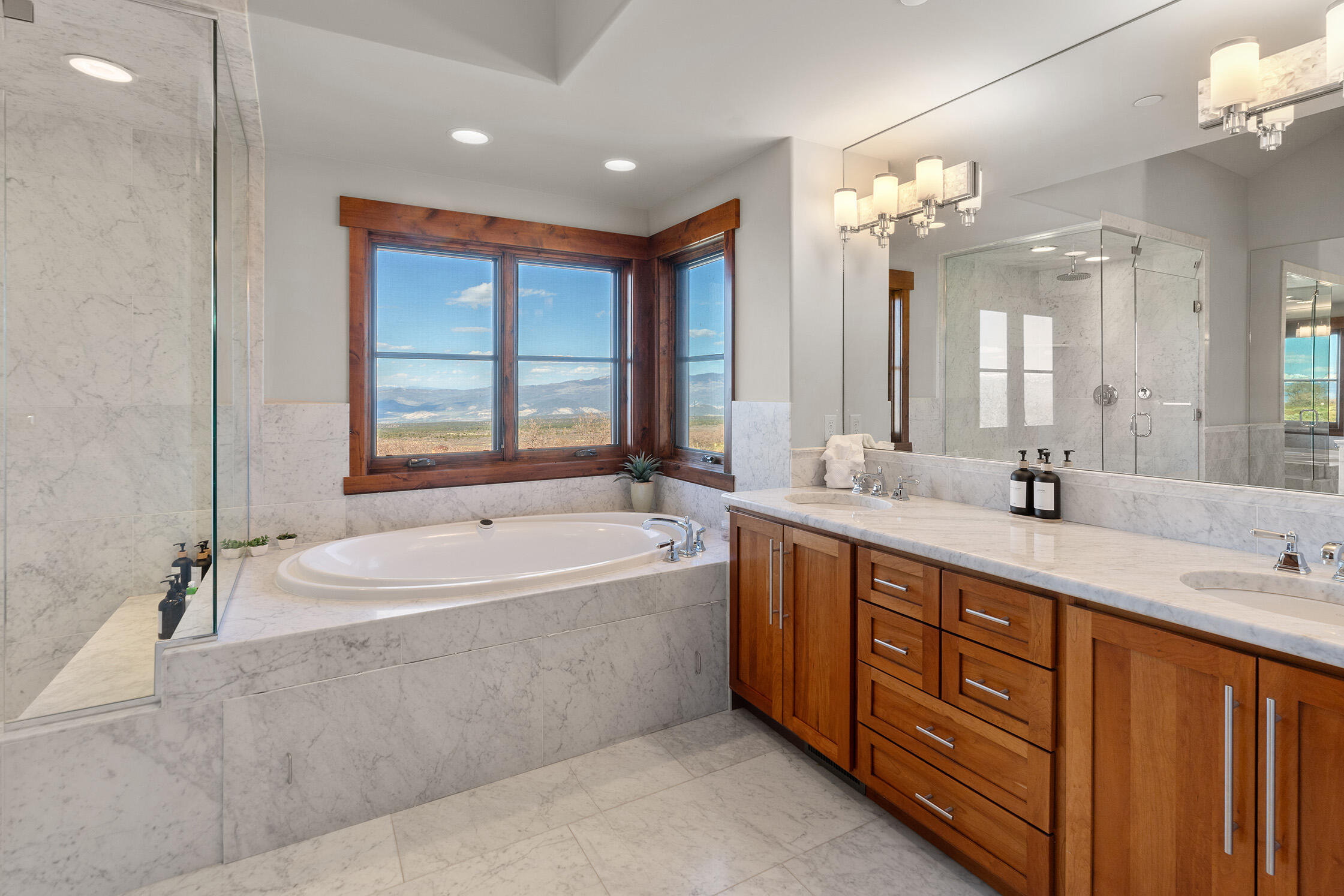1221 Cornerstone Loop Montrose, CO 81403 - Photo 22 of 44 a spacious bathroom with a tub sink double vanity granite and a tub