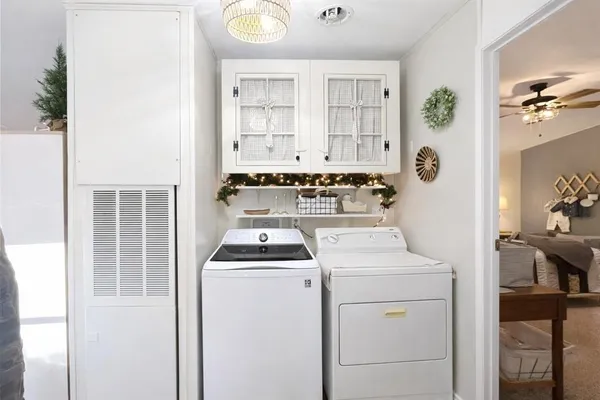 a utility room with closet dryer and washer