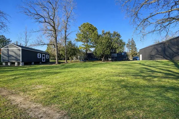 a view of a field of grass and trees