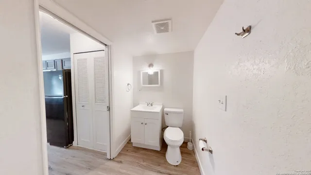 a bathroom with a toilet sink and shower