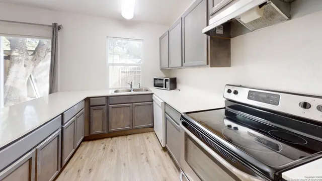 a kitchen with a stove and a sink