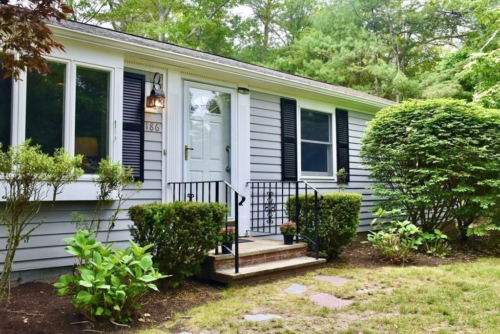 186 Sheaffer Road Barnstable, MA 02632 - Photo 3 of 29 a front view of a house with a garden