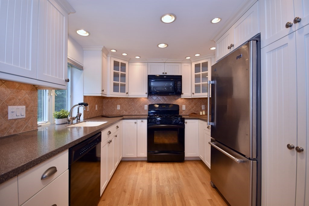 186 Sheaffer Road Barnstable, MA 02632 - Photo 10 of 29 a kitchen with stainless steel appliances granite countertop a refrigerator a sink and a stove