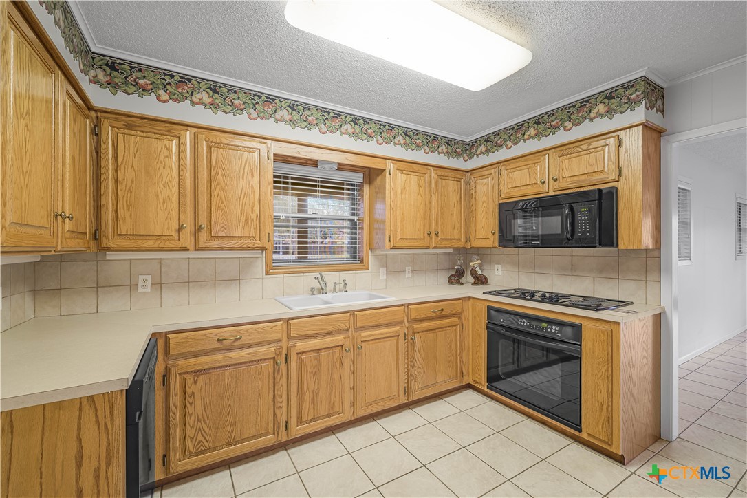 406 Blyth Road Victoria, TX 77904 - Photo 20 of 32 a kitchen with a sink cabinets and window