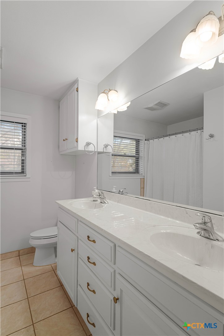 406 Blyth Road Victoria, TX 77904 - Photo 23 of 32 a bathroom with a sink and a mirror