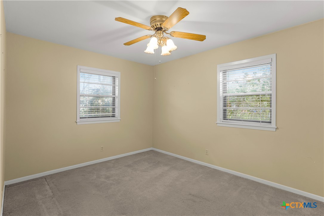 406 Blyth Road Victoria, TX 77904 - Photo 24 of 32 an empty room with windows and fan