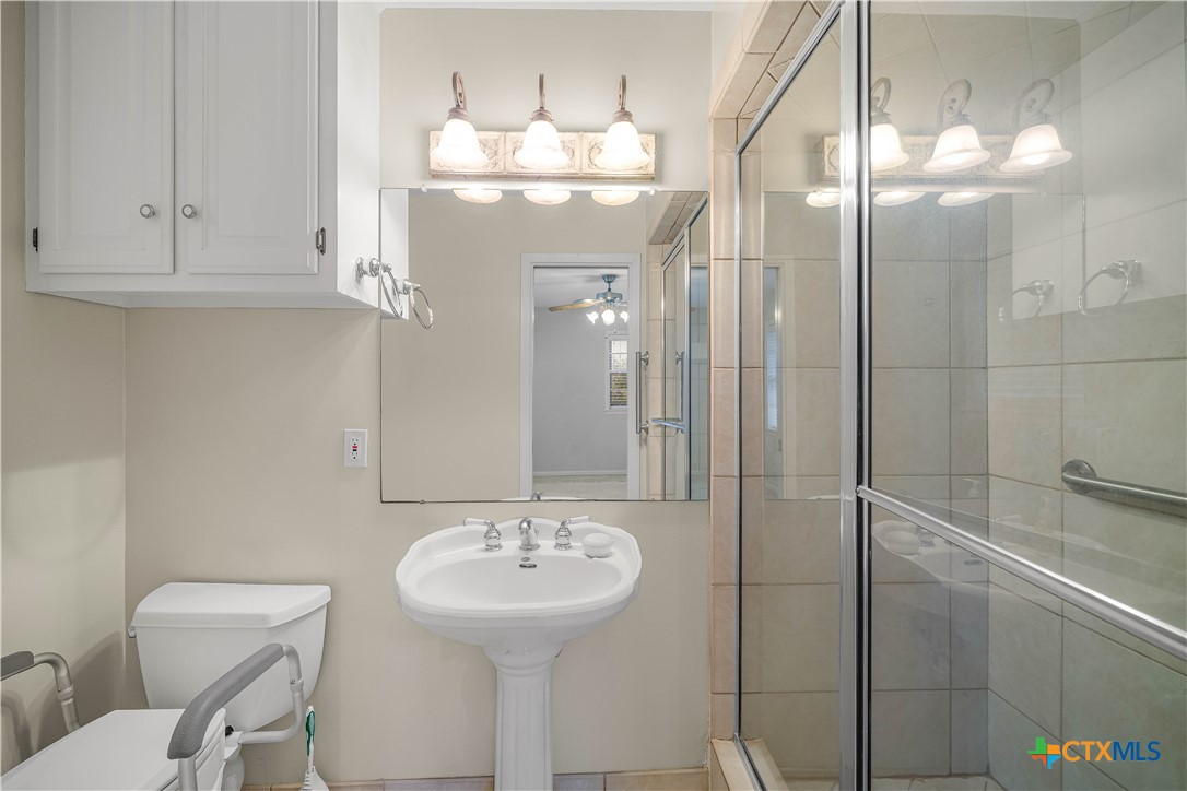 406 Blyth Road Victoria, TX 77904 - Photo 27 of 32 a bathroom with a sink a toilet and shower
