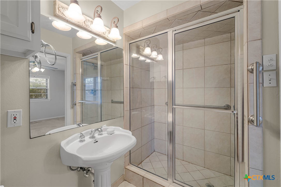 406 Blyth Road Victoria, TX 77904 - Photo 28 of 32 a bathroom with a sink shower and a mirror