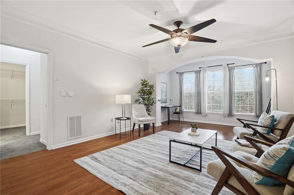 a living room with furniture and wooden floor