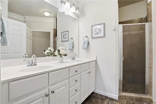 a bathroom with a double vanity sink mirror and shower