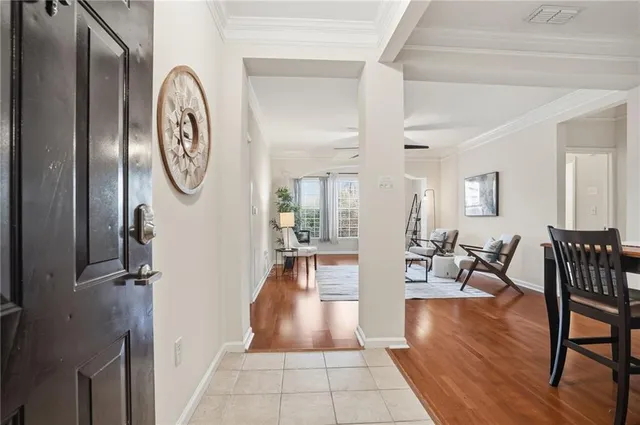a living room with furniture a wooden floor and a potted plant