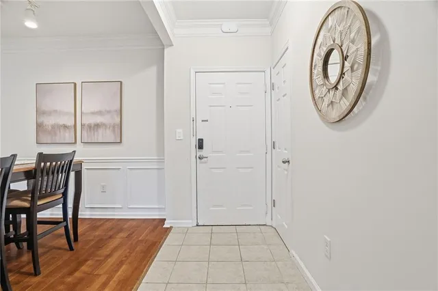 a view of a hallway with entryway wooden floor and front door