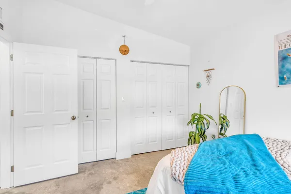 a bedroom with a bed and a entryway