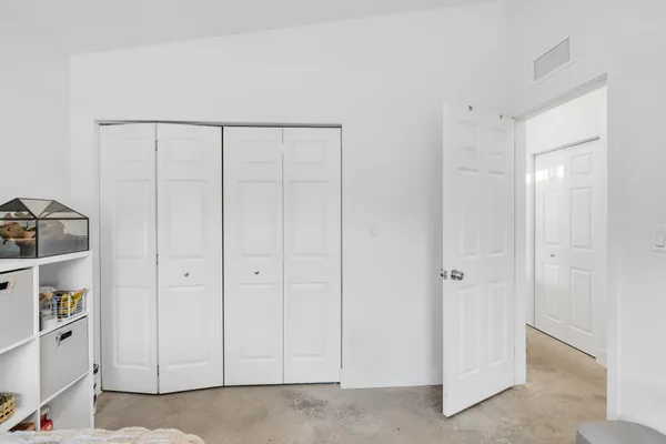 a view of a closet area with en suite bathroom