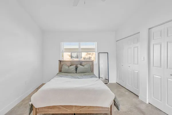 a bedroom with a bed and white walls