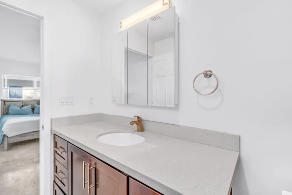 a bathroom with a sink and vanity