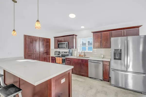 a kitchen with a refrigerator a stove a sink dishwasher and a refrigerator