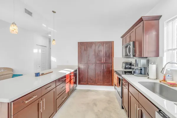 a kitchen with a sink stove and cabinets