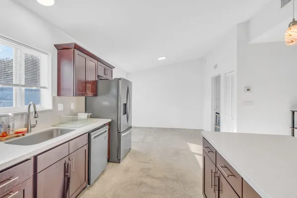 a kitchen with a sink stove and refrigerator