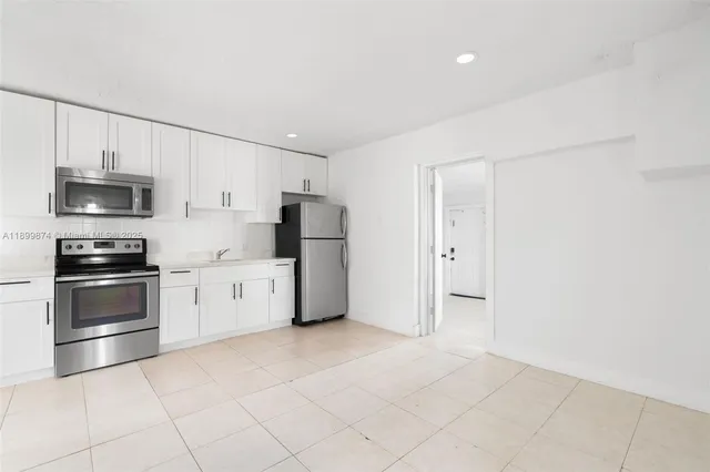 a kitchen with stainless steel appliances and white cabinets