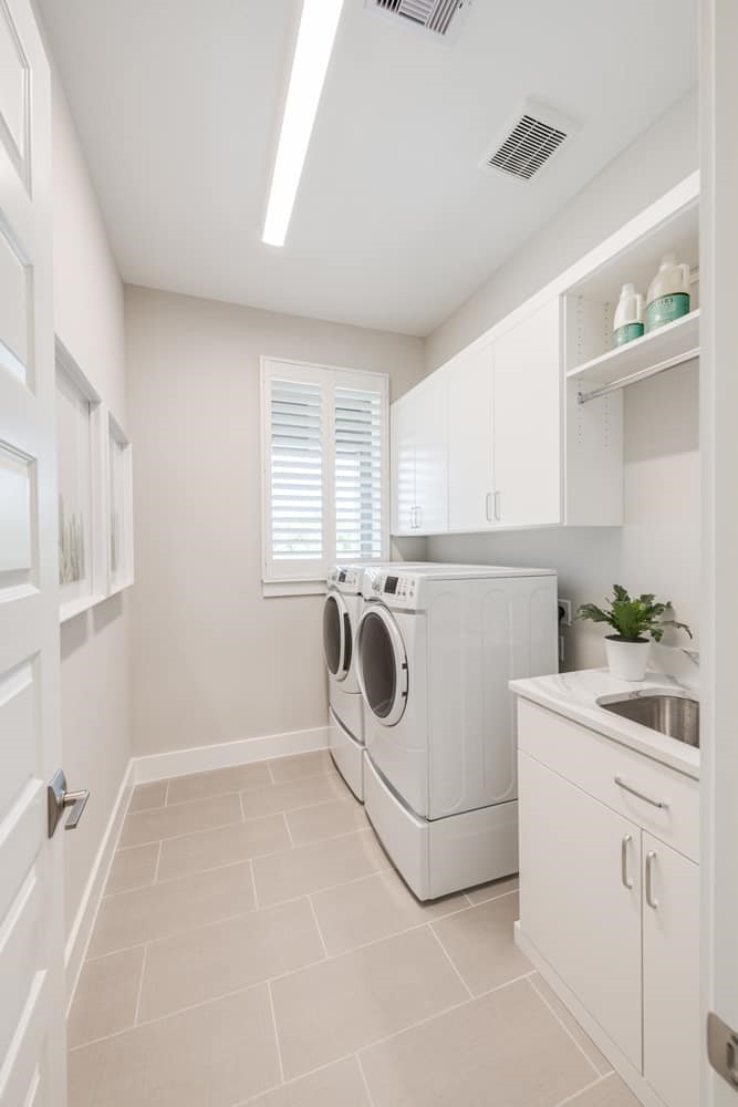 4811 Morning Spgs Drive Spring, TX 77386 - Photo 12 of 37 a utility room with cabinets washer and dryer