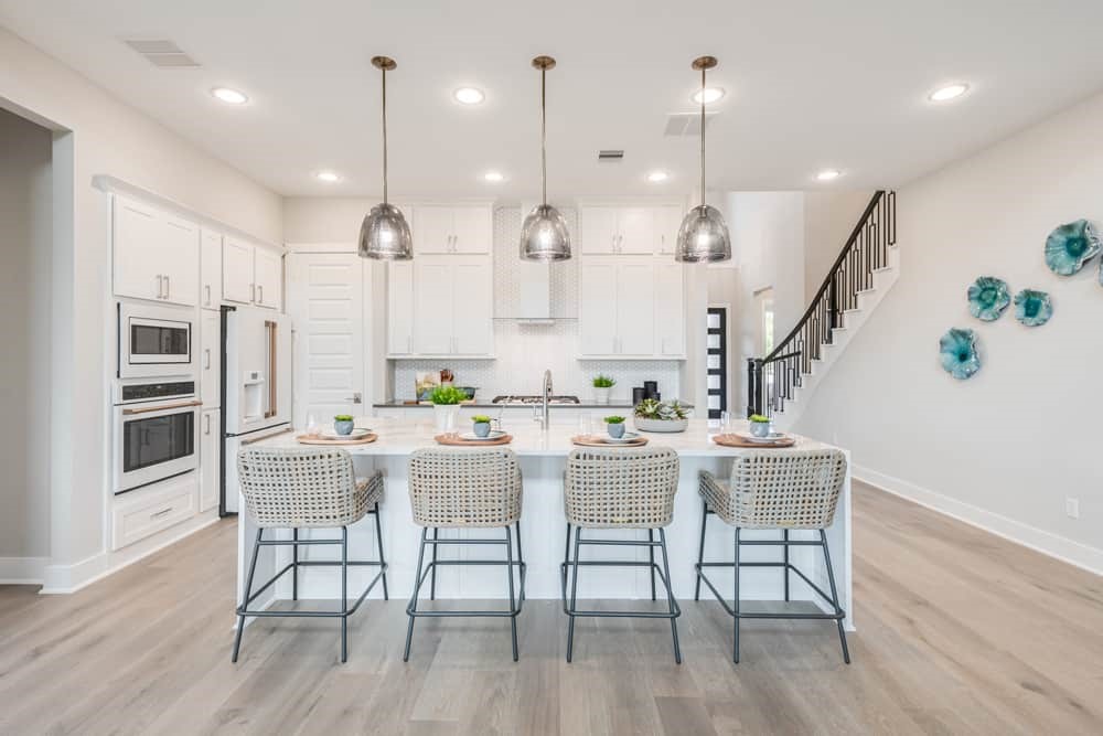 4811 Morning Spgs Drive Spring, TX 77386 - Photo 2 of 37 a kitchen with stainless steel appliances kitchen island wooden floors and view living room