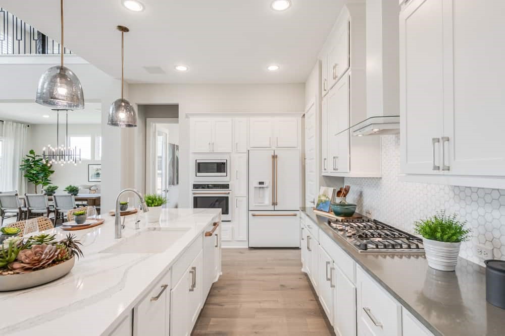 4811 Morning Spgs Drive Spring, TX 77386 - Photo 4 of 37 a kitchen with kitchen island stainless steel appliances a sink a stove a window and cabinets
