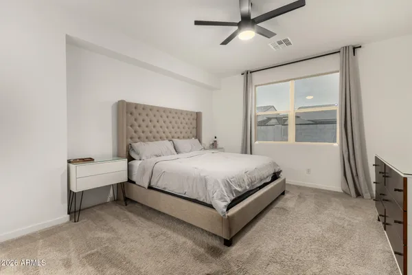 a bed room with a bed and a night stand