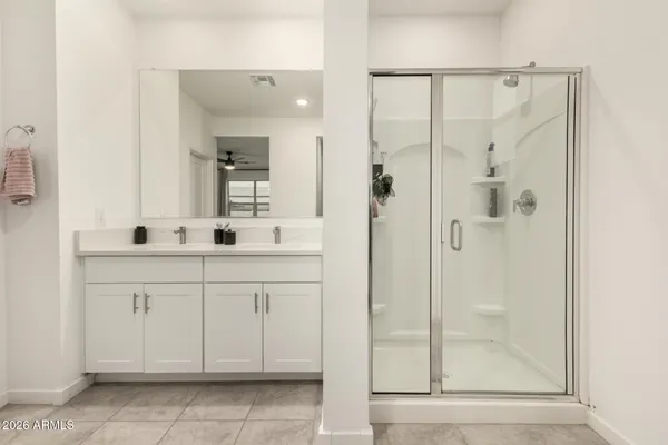 a bathroom with a shower sink and mirror